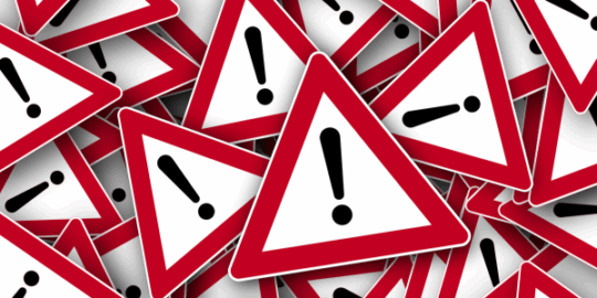 A pile of alert signs representing ToolShell: A wake-up call for SharePoint data management