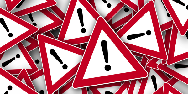 A pile of alert signs representing ToolShell: A wake-up call for SharePoint data management